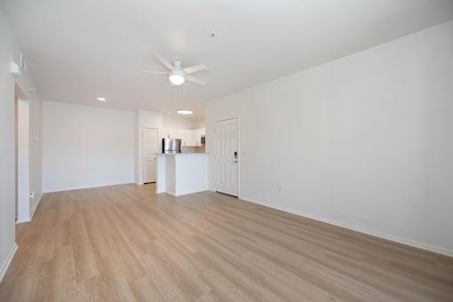A room with a wooden floor and a ceiling fan.