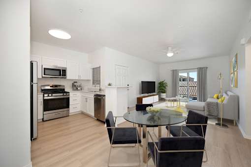 A modern kitchen with a glass table and chairs.