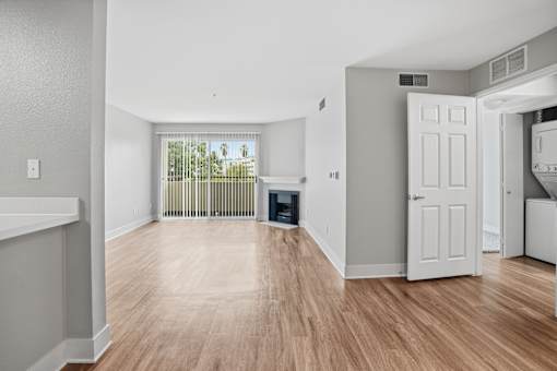 A room with wooden floors and white walls.