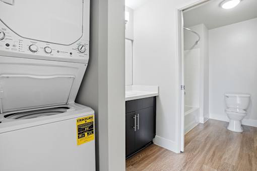 A white washing machine with a yellow sticker on it.