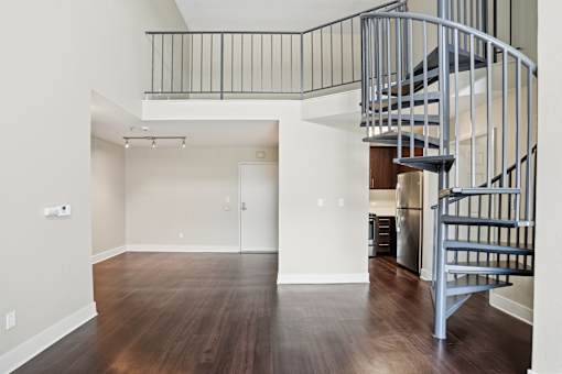 A large open living room with a spiral staircase.