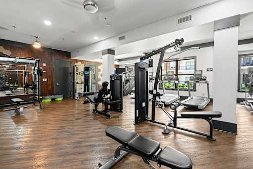 A gym with a variety of equipment including a leg press machine.