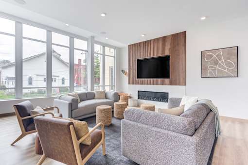 a living room with couches and chairs and a fireplace