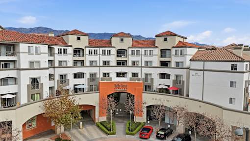 A large apartment complex with a red arched entrance.