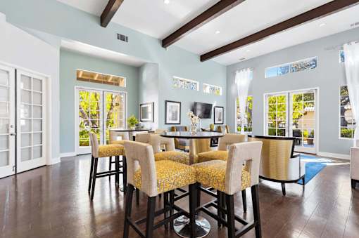 A dining room with a table set for six.
