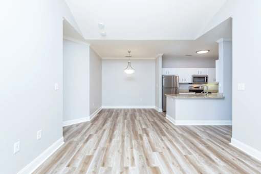 A kitchen area with a refrigerator, microwave, and oven.