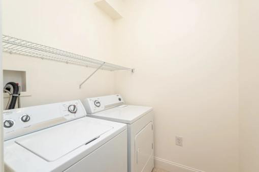 A white dryer and washer in a laundry room.