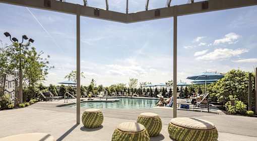A pool area with a clear blue sky in the background.