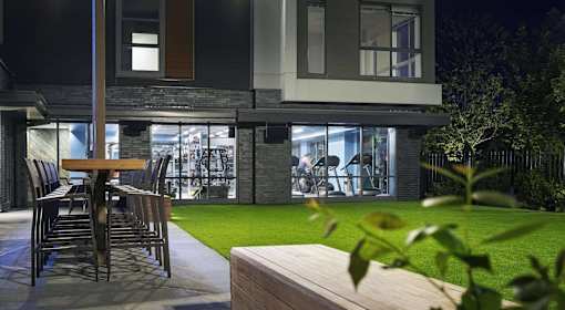 A modern house with a patio and a table.