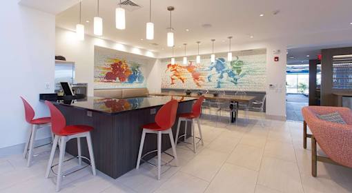 A modern bar area with a world map on the wall.