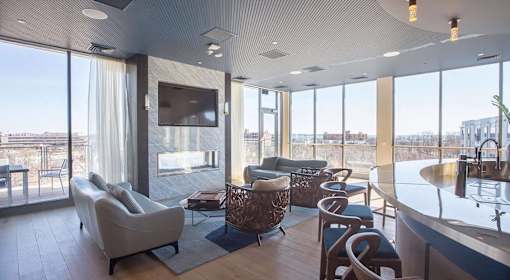 A modern living room with a large window overlooking a cityscape.