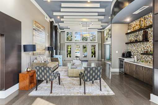 a living room with a couch and chairs and a table
