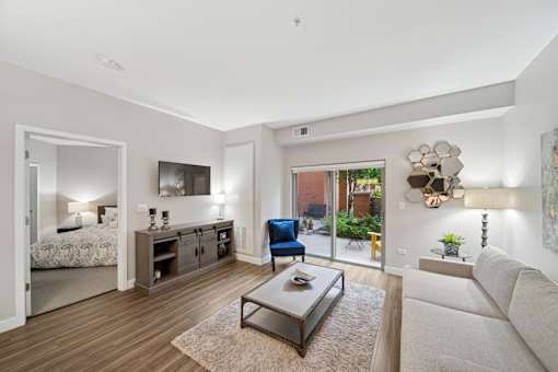 A modern living room with a blue chair and a grey couch.