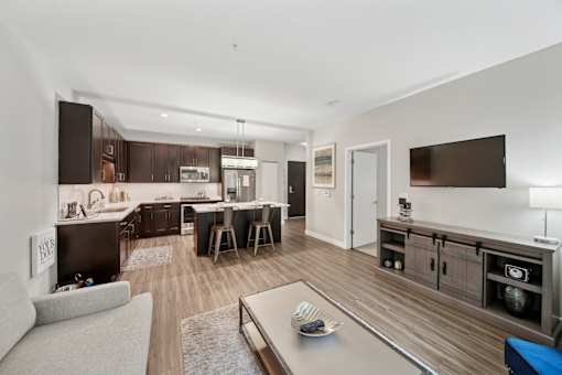 A modern kitchen with a dining area and a living room.