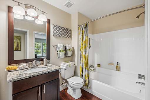 A bathroom with a white toilet, a sink, and a shower.