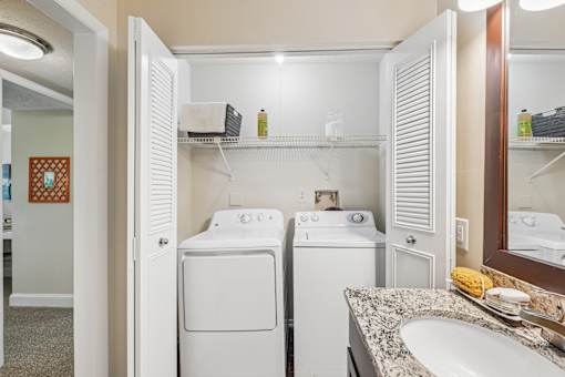 A small laundry room with a washer and dryer.