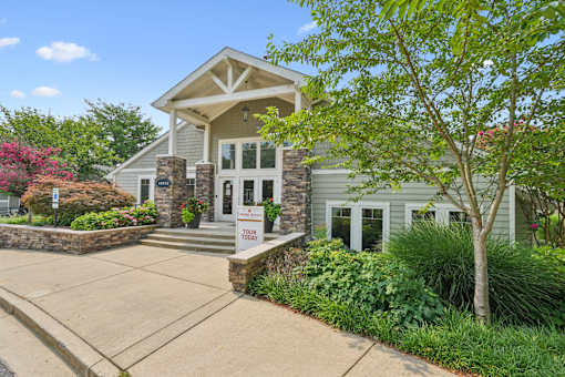 A house with a stone pillar and a sign that says "Your Today" in front of it.
