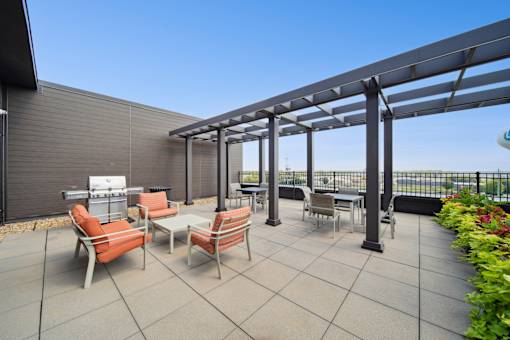 A patio with a table and chairs under a pergola.