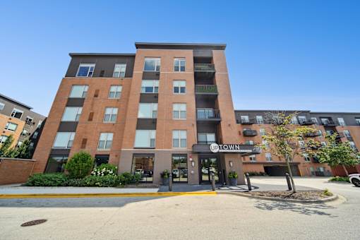 A multi-story building with the name "UPTOWN" on the front.