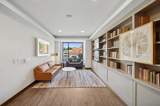 A living room with a brown sofa and a coffee table.
