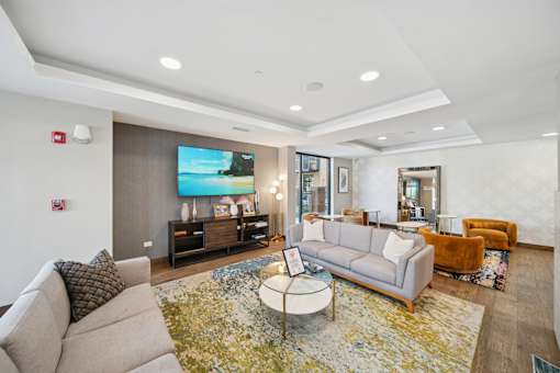 A living room with a grey couch and a coffee table.