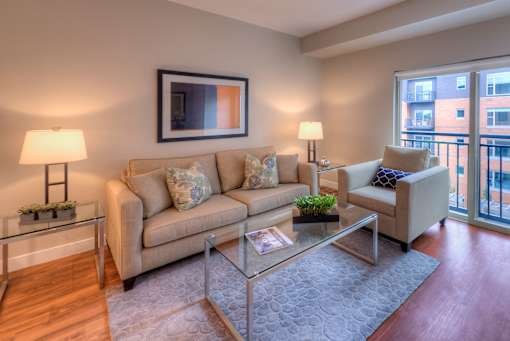 A living room with a couch, a chair, and a coffee table.