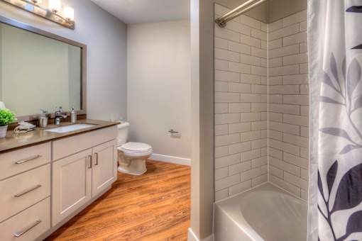 A bathroom with a toilet, sink, and shower.
