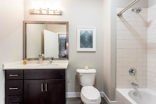 A bathroom with a toilet, sink, and a shower.