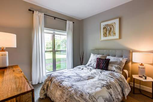 A bedroom with a large bed and a wooden table.