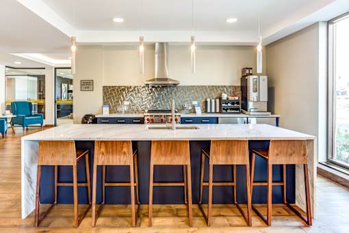 A kitchen with a bar area and a stove top oven.