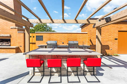 A table with four chairs is set up outside on a patio.