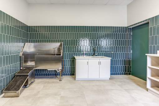 A kitchen with a sink, stove, and counter.