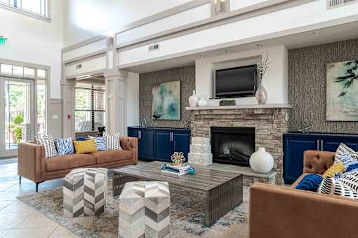 A living room with a fireplace and a television on the wall.