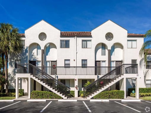 Pet-Friendly Apartments in Coconut Creek, FL – Waterview at Coconut Creek – community building with stairs and parking spots in front