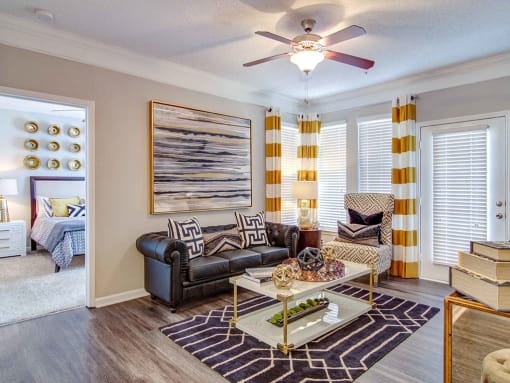 Pet-Friendly Apartments in Alpharetta, GA – The Ascent at Windward – living room with lots of space, hardwood floors, ceiling fans and large windows