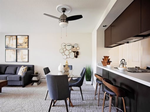 Pet-Friendly Apartments - Bridge Creek Apartments - Living Room with Ceiling Fan and Modern Dining Area