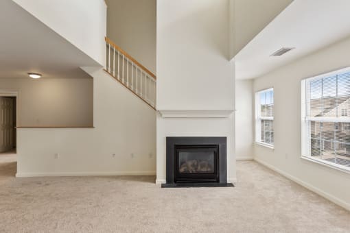 Orchards Apartments Marlborough ma apartment loft style apartments photo of living room with fireplace and stairs with carpet flooring and multiple windows