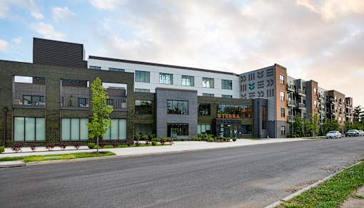 A modern apartment complex named STERRA is shown in the image.