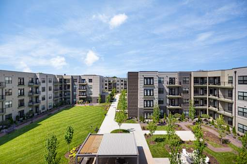 Apartment complex with a green lawn in front.