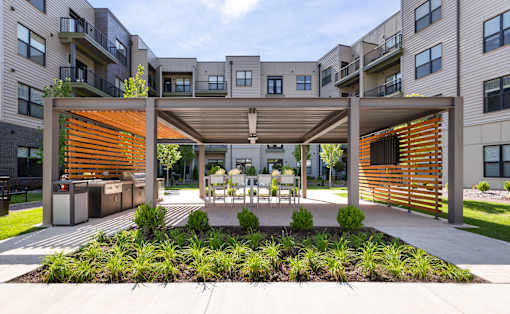 A modern outdoor seating area with a wooden slat screen.