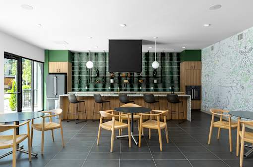 A modern kitchen with a bar area and wooden chairs.