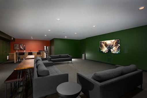 A modern living room with a grey couch and a wooden table.