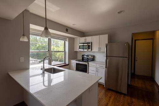 an example of a kitchen with white cabinets and stainless steel appliances