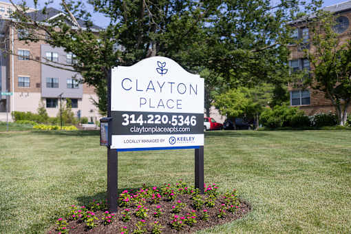 a sign that says clayton place in front of a building