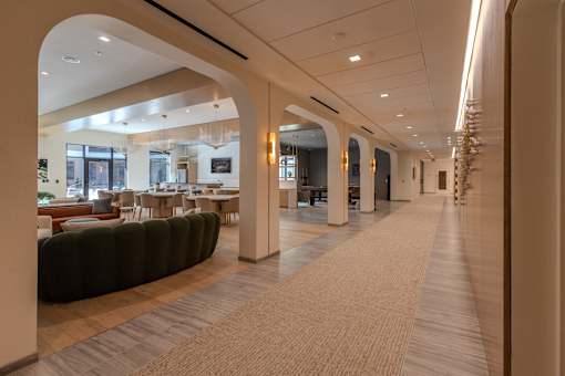 a view of the lobby of a hotel with tables and chairs