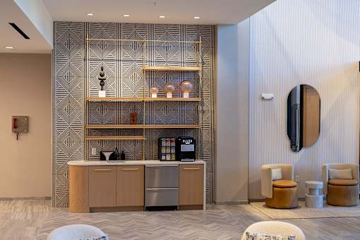 the lobby of a hotel with a coffee machine and a counter