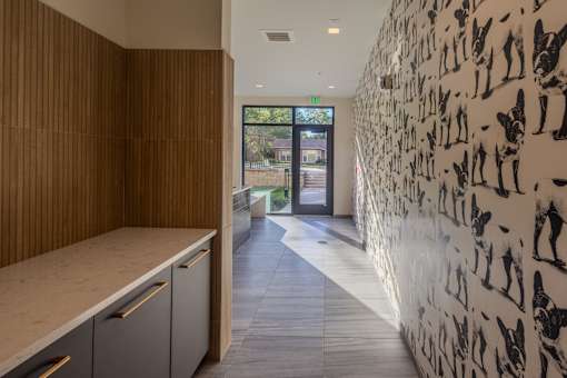 a hallway with a white wallpaper with people on it
