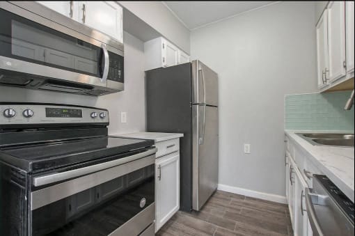 a kitchen with stainless steel appliances and a refrigerator