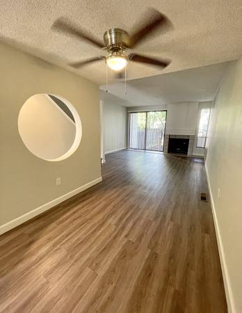 a room with a ceiling fan and a mirror