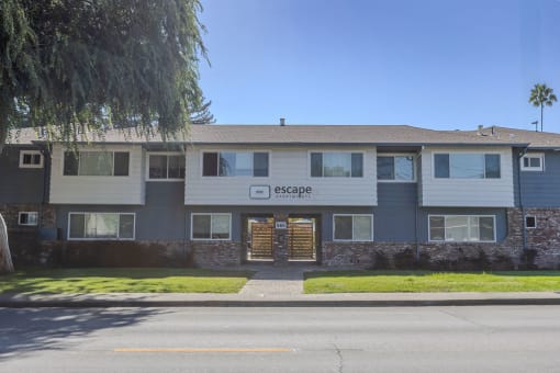 an apartment building with a street in front of it